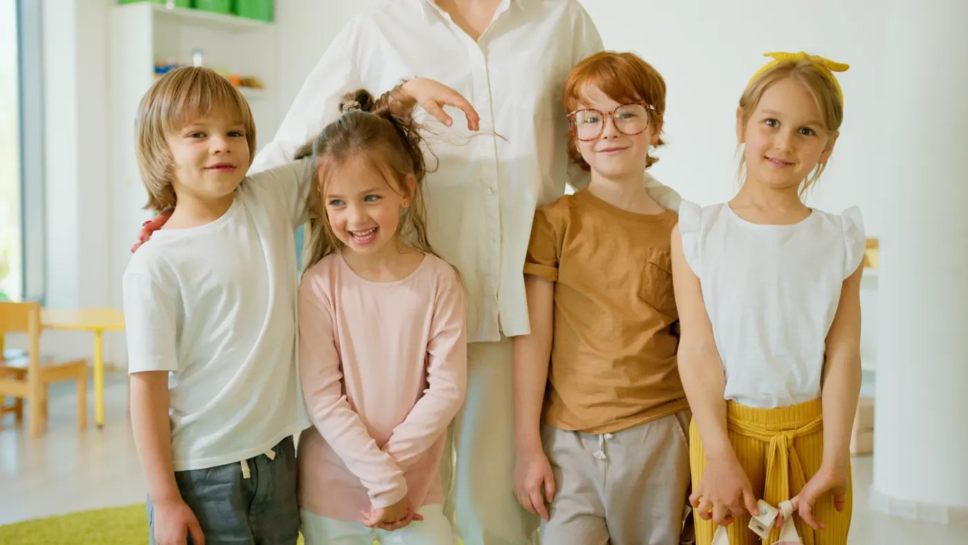 A group of smiling, confident children together in the classroom