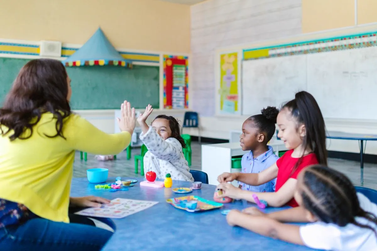 Teacher and children sharing a hands-on learning activity